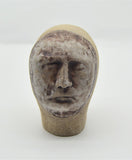 Sally Fitchard's 'Mottle'. A small ceramic head with a mottled face. FRONT ON