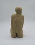 Detail of one kneeling figure as part of 'Multiple Kneels'. Sally Fitchard's 'Multiple Kneels (Telling)'. A triptych of ceramic kneeling figures.