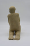 Back profile of one kneeling figure as part of Sally Fitchard's 'Multiple Kneels (Telling)'.