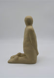 Side profile of one kneeling figure as part of Sally Fitchard's 'Multiple Kneels (Telling)'.