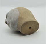 Sally Fitchard's 'Tommy' a small ceramic head with a white face. UNDERSIDE