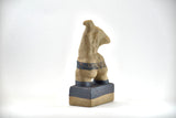 Title: Plinth Woman Artist: Sally Fitchard Medium: clay sculpture Size: 21.5 cm x 11 cm x 7.2 cm (back view, left side). Colour comprises sand and charcoal