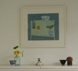 A photo of Fiona MacRae's 'Yellow and Blue' in situ. The artwork is framed in a wooden frame, which is painted in white, and mounted in white. 