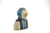 Title: Spaceman Artist: Sally Fitchard Medium: clay sculpture Size: 14 cm x 10.4 cm x 8.2 cm (right side). Colour comprises sand, charcoal and teal green