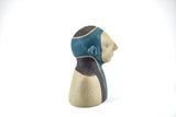 Title: Spaceman Artist: Sally Fitchard Medium: clay sculpture Size: 14 cm x 10.4 cm x 8.2 cm (side profile, left side). Colour comprises sand, charcoal and teal green