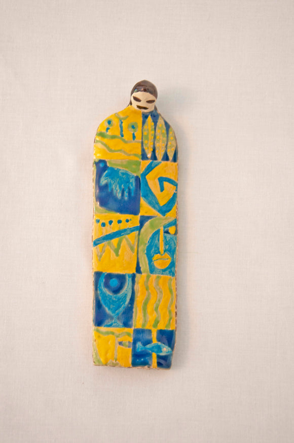 Elham Hemmat's 'Docile Bodies 13', a ceramic figure adorned with a yellow and blue pattern.