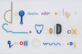 Fiona MacRae's 'Doggerel is an assemblage made from ocean plastic, mounted on white board and framed in a white frame. 