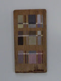 Wooden panel with geometric pattern on a white background