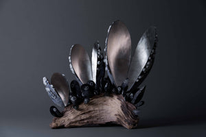 Lucy Gray's 'Barnacles' is a mixed-media sculpture, comprising deadwood, jesmonite and silver leaf. The artwork manifests feelings of trauma and hurt that you carry with you into later life.