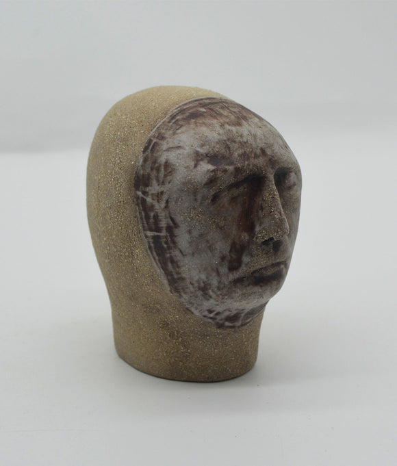 Sally Fitchard's 'Mottle'. A small ceramic head with a mottled face RIGHT SIDE.