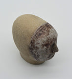 Sally Fitchard's 'Mottle'. A small ceramic head with a mottled face. BIRDSEYE VIEW