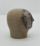 Sally Fitchard's 'Mottle'. A small ceramic head with a mottled face. RIGHT PROFILE