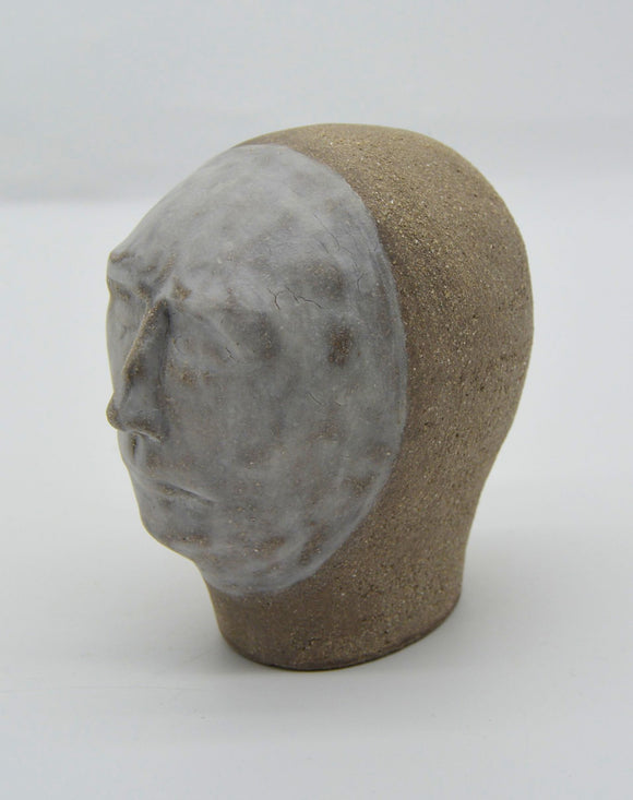 Sally Fitchard's 'Mr Silver'. A small ceramic head with a white face. LEFT PROFILE I