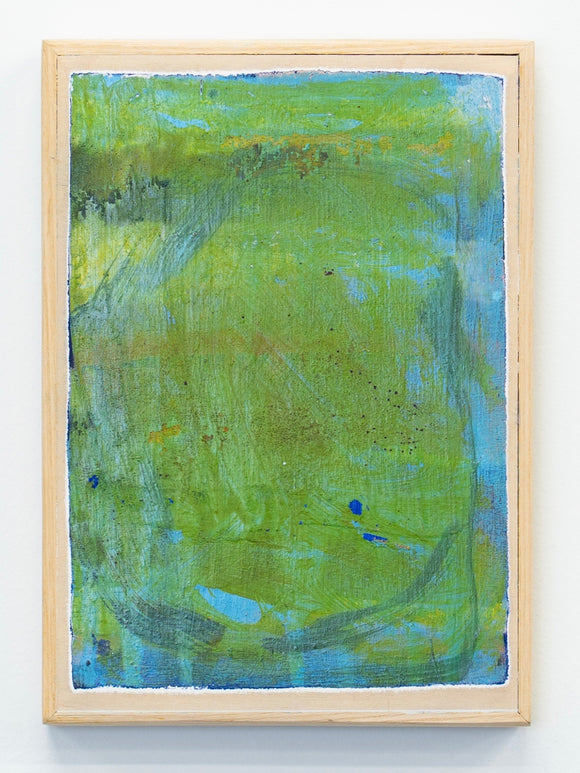 Abstract painting with green and blue hues in a wooden frame on a white wall