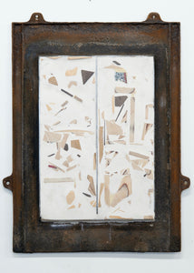 Abstract artwork with geometric shapes in an old metal window frame on a white background