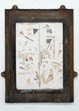 Abstract artwork with geometric shapes in an old metal window frame on a white background
