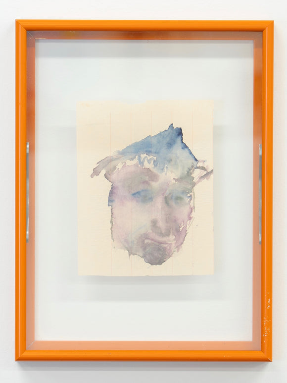 Framed watercolor painting of a face with an orange frame on a white wall