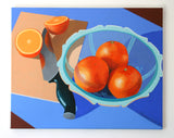 Still life painting of oranges and a knife on a blue background by Marcus Bolt. The painting is on stretched canvas and pictured here, mounted on a white wall.