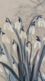 Detail shot. Picture is of snowdrops with shrubbery faintly rendered in the background. Muted palett of inky blues and greys with white flowers.