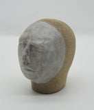 Sally Fitchard's 'Tommy' a small ceramic head with a white face. LEFT PROFILE II