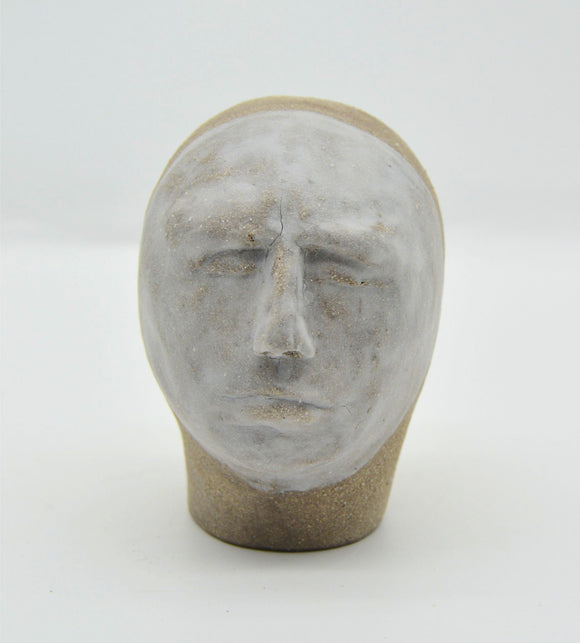 Sally Fitchard's 'Tommy' a small ceramic head with a white face. FRONT PROFILE