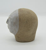 Sally Fitchard's 'Tommy' a small ceramic head with a white face. LEFT PROFILE I