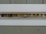 Close-up of a wooden strip with color swatches on a white background