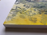 Corner of abstract painting on board on a white surface