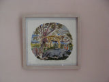 Framed artwork of a nature scene with animals on a light pink wall.