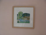 Framed artwork of a landscape on a beige wall
