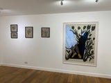 A photo of Maureen Nathan's 'Midden' in its frame and hung on the wall alongside other artworks