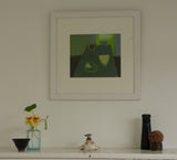 Photo of Fiona MacRae's 'Green Pepper' in situ. The artwork is framed in a wooden frame, painted white and mounted in off-white. 